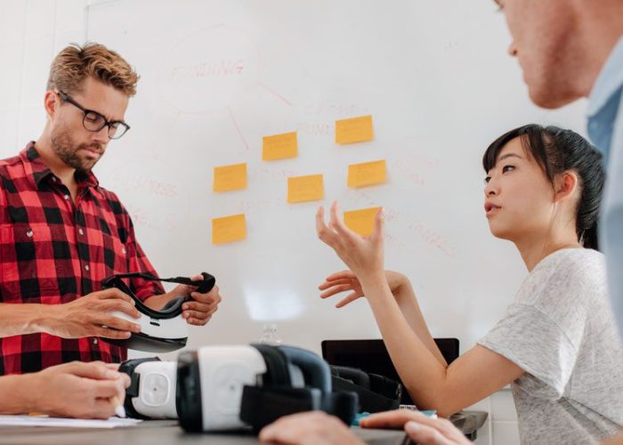 A group of people working on a whiteboard.